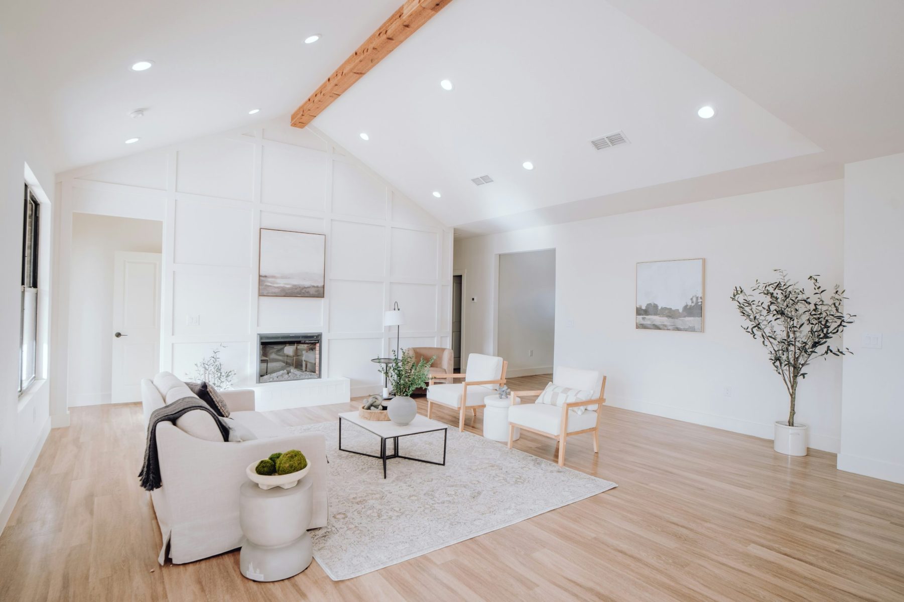living room with white chairs and wood floor
