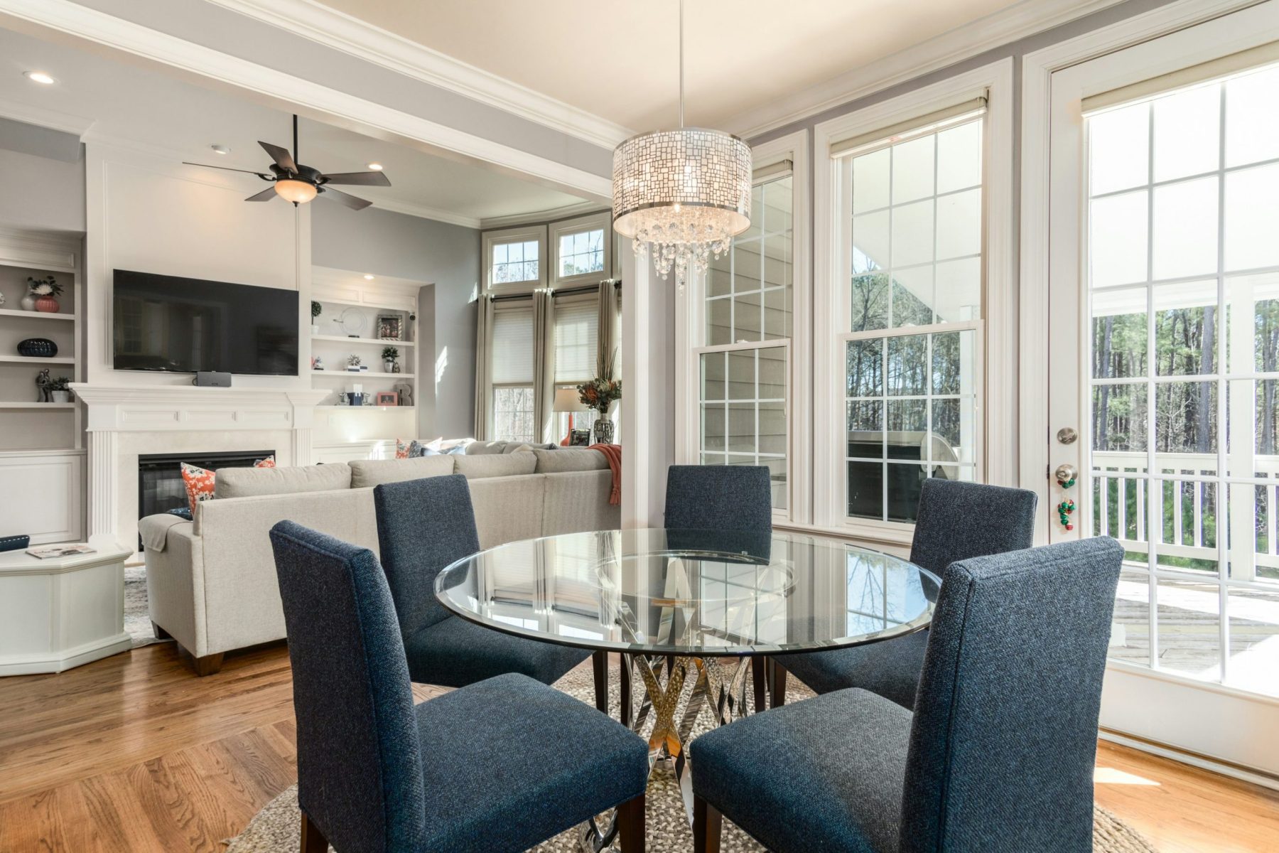 dining area with glass table and five gray chairs