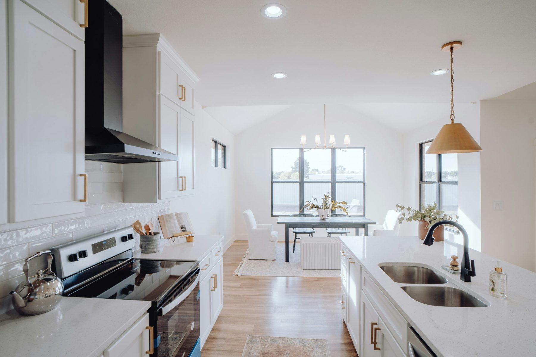 white kitchen with oven and double sinks