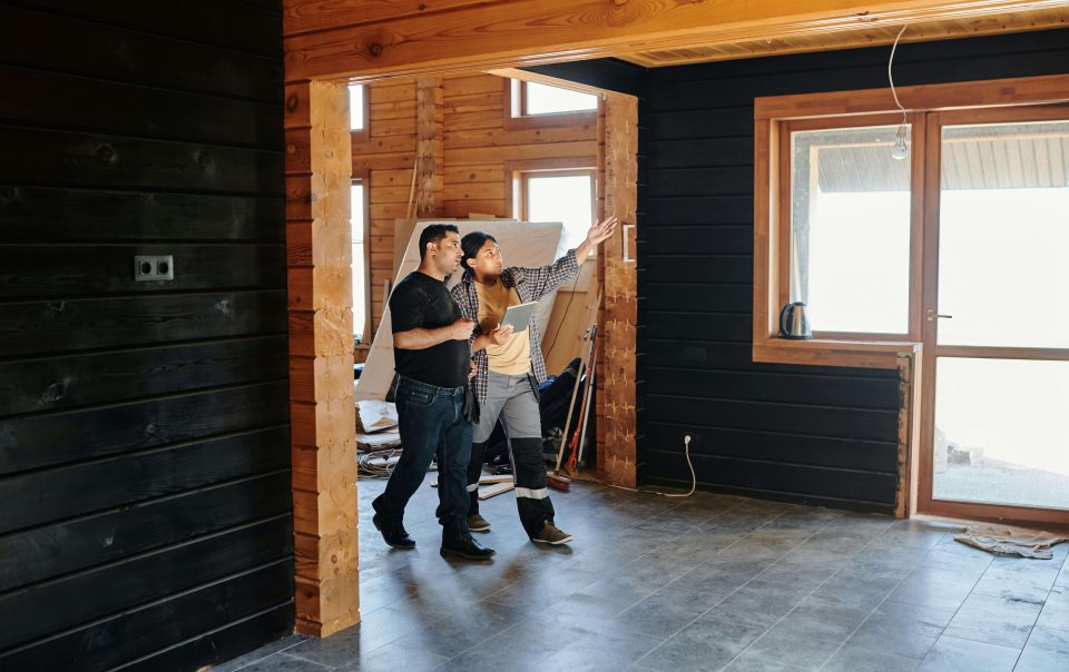two people walking through a construction project