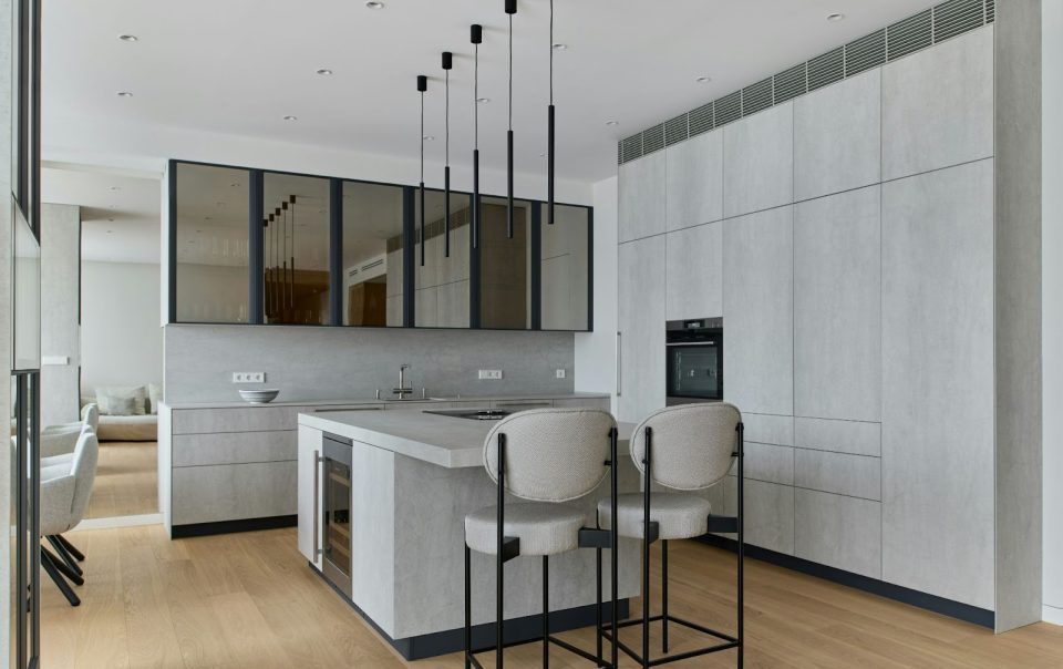 A gray kitchen with modern lightning