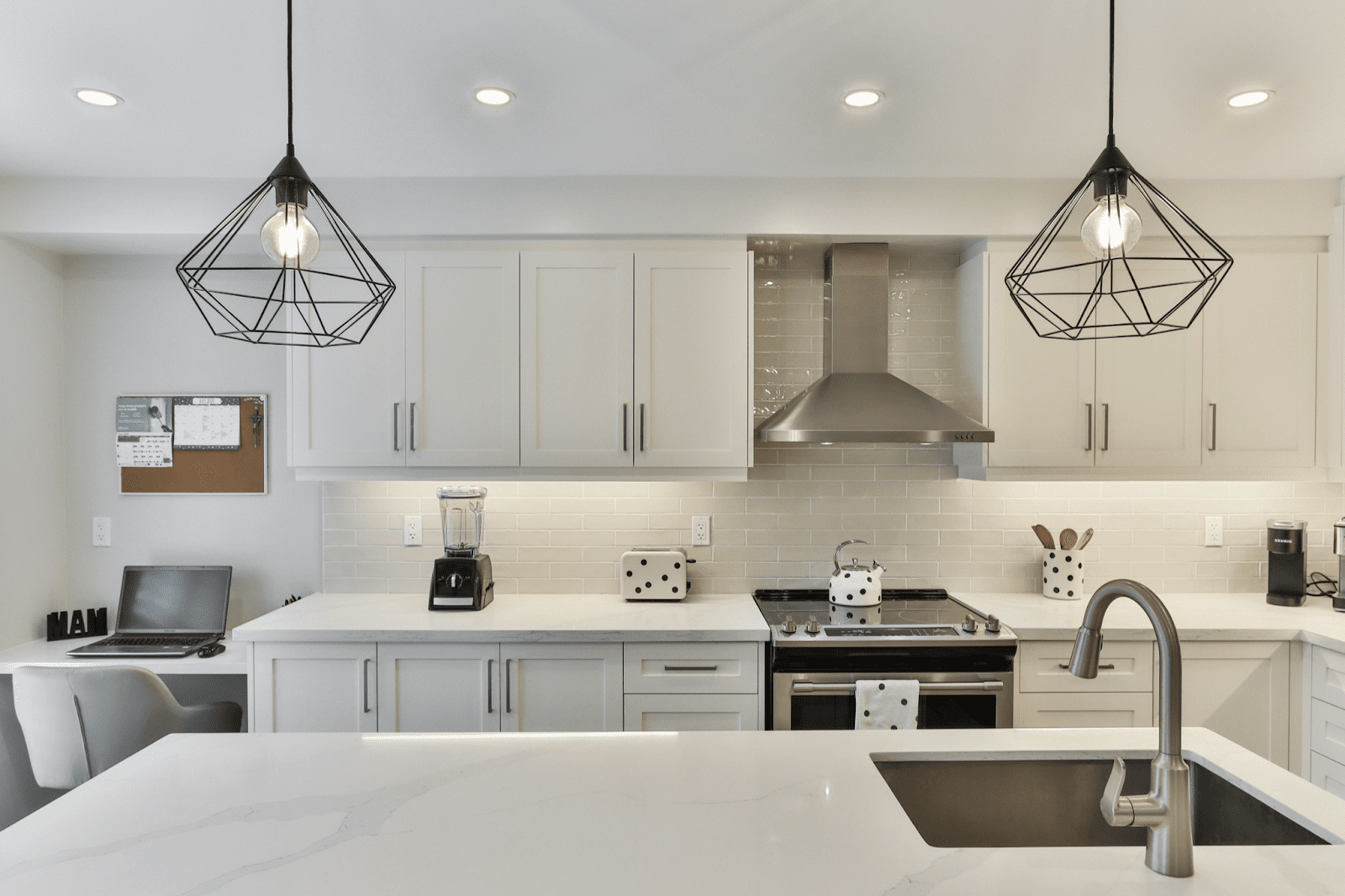 white kitchen with black pendant lighting