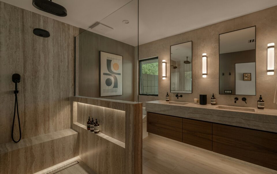 a bathroom with a double vanity and rainfall shower