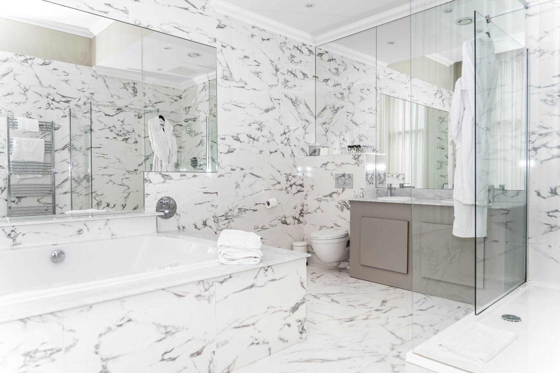 A bathroom with marble floors and a tub