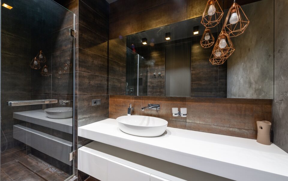 A modern bathroom with statement lighting
