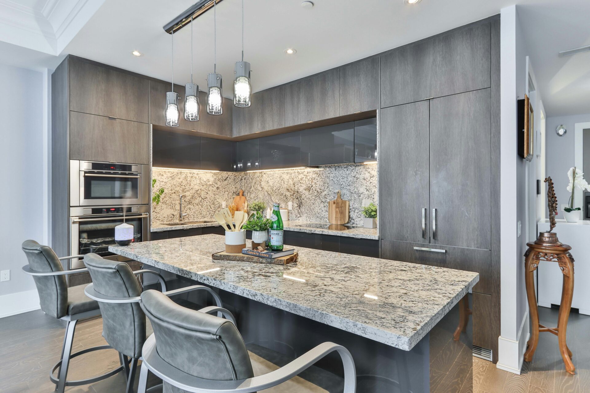 A kitchen with gray countertops and cabinets